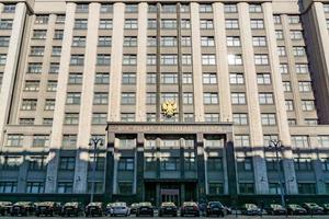 Moscow, Russia, 2018 - Facade of the State Duma, Parliament building of Russian Federation and parked cars near the entrance photo