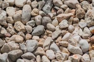 Gravel background texture. Close up of little stones on the ground photo