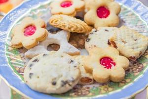 Vintage rustic plate with christmas cookies. Sweet pastry for children photo