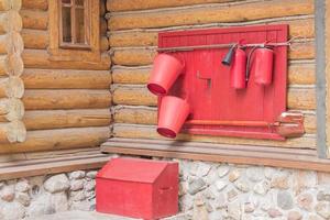 wooden shield with fire fighting tools on the wall of the house, close up photo