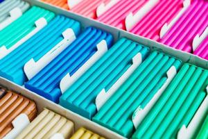 Rainbow colors of modeling clay. Multicolored plasticine bars ina box, background texture photo