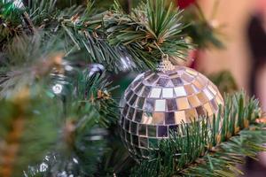 Christmas and New Year holidays background.  Christmas tree decorated with silver disco ball. Celebration concept photo