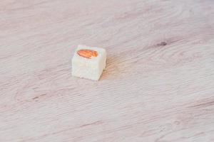 Traditional turkish delight on a wooden table. Assorted Oriental sweets. photo