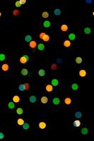 Multicolored abstract bokeh on black background photo