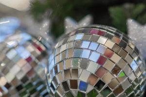 Christmas and New Year holidays background.  Christmas tree decorated with silver disco ball. Celebration concept photo