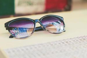 Fashion sunglusses on a table. Summer concept. vintage color style photo