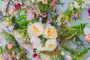 Artificial flowers - floristic arrangement of peonies on the wall. Floral background photo