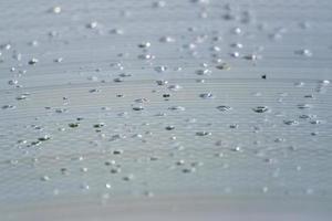 Transparent Polycarbonate plastic sheet with drops, background texture with space for text photo
