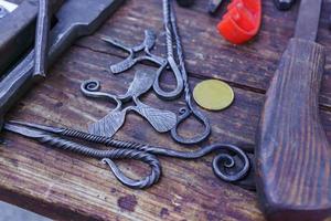 blacksmith tools and workplace  - anvil, hammers, blacksmith tongs, firesteel. photo