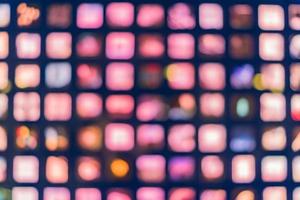 Defocused abstract multicolored bokeh lights background. Square windows at night photo