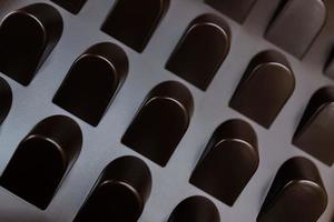 empty box of chocolate shapes. Abstract texture background photo