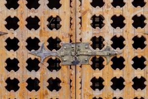 close up locked carved wooden gate photo