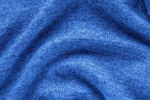 Trend color 2020 classic blue, knitted fabric background for design. photo