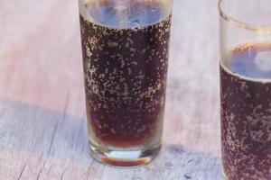 two jars of cold fresh russian kvass on wooden table outdoors photo