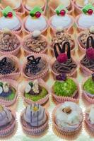 Pastry shop display window with variety of mini desserts and cakes, selective focus photo