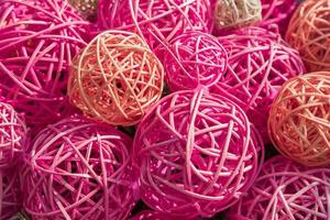 Plenty of multicolored ratan balls together. Colorful background in pink colors photo