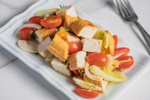 Fried tofu salad with fresh vegetables. Weight loss diet. photo