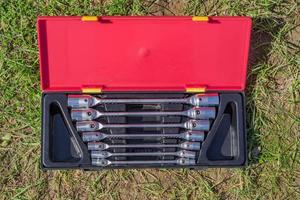 set of socket wrenches in red and black case on the ground,  top view of workers tools photo