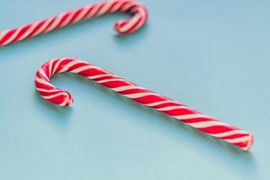 Merry Christmas and Happy New Year greeting card. Two candy canes on blue background with copy space for your text. photo