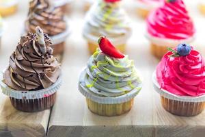 Pastry shop display window with variety of cupcakes, selective focus photo