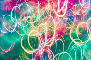 Multicolor neon green and pink lights trails background. Bokeh lens flare glow. Festive backdrop photo
