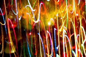 Abstract burred texture background of colorful bokeh motion. Long exposure of small neon lights photo