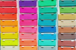 Rainbow colors of modeling clay. Multicolored plasticine bars ina box, background texture photo