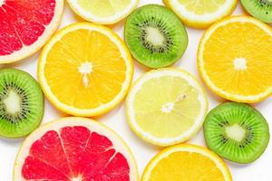 citrus slices - kiwi, oranges and grapefruits on white background. Fruits backdrop photo