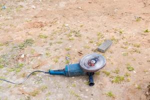 operating angle grinder on the ground. photo