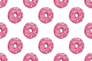 pink frosted donuts with white sprinkles on white background. Seamless pattern photo