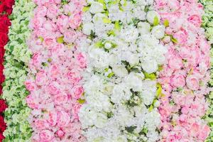 artificial blooming peonies and roses of white, red and pink color background photo