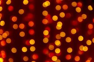 Bokeh abstract texture. Beautiful christmas background in orange colors. Defocused image photo