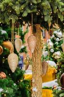 close up of christmas trees decorated with sparkling cones and garland with lights on. Festive background with copy space for your projects photo