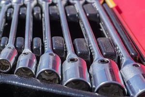 set of socket wrenches in a case,  close up of workers tools, selective focus photo