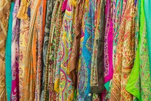 Range of colorful silk scarfs in the shop. photo