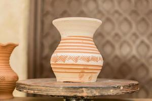 clay jar dries on round stand photo