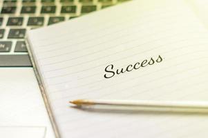 Writing note showing Success. Inspirational motivating quote on notebook photo
