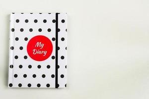 libreta de lunares en blanco y negro con círculo rojo y la inscripción de mi diario en la portada.