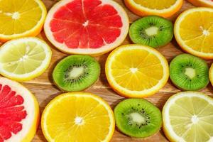 frame with slice of oranges, lemons, kiwi, grapefruit pattern isolated on white background. photo