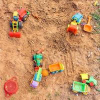 Playground with different toy transportation. Trucks and excavators for playing in the sand photo