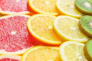 close up of citrus slice, kiwi, oranges and grapefruits. Fruits backdrop photo