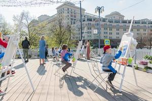 Moscow, Russia, 2019 - Open air workshop.  Easter Holiday festival in Moscow. Children painting photo