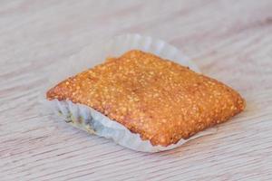 Honey bar made of sesame seeds. Orient delight on wooden table. photo