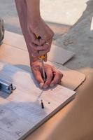 furniture assembling - Carpentry screws for a knock down wooden table. photo