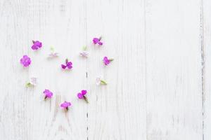 Chamaenerion flowers on white wooden background photo