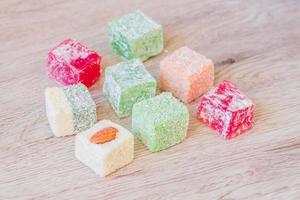Traditional turkish delight on a wooden table. Assorted Oriental sweets. photo