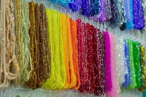 Colorful crystal and perl beads necklaces. Background pattern. Handicraft fashionable for women. Selective focus photo