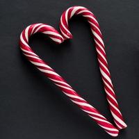 Traditional  candy cane on black background. New Year and Christmas concept photo