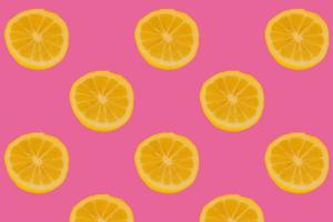 cutted fresh lemons  on bright pink background photo