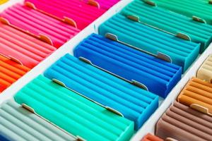 Bright colors of modeling clay. Multicolored plasticine bars ina box, background texture photo